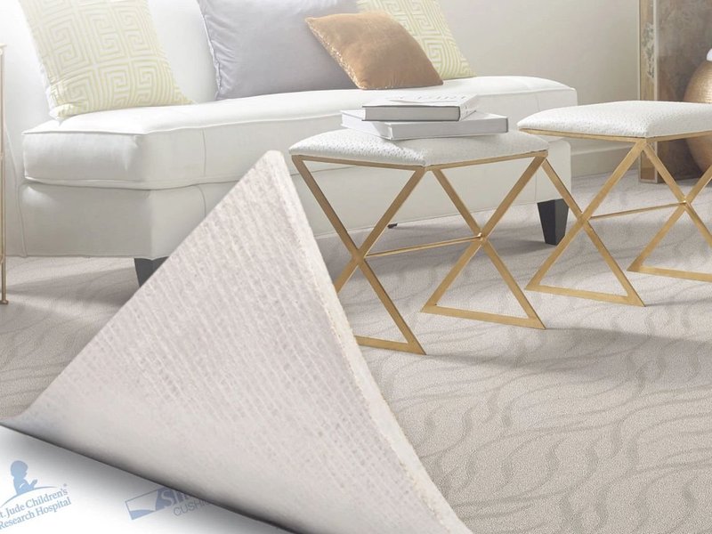 Carpet being peeled back to reveal carpet cushion beneath - River City Flooring in Missoula, MT